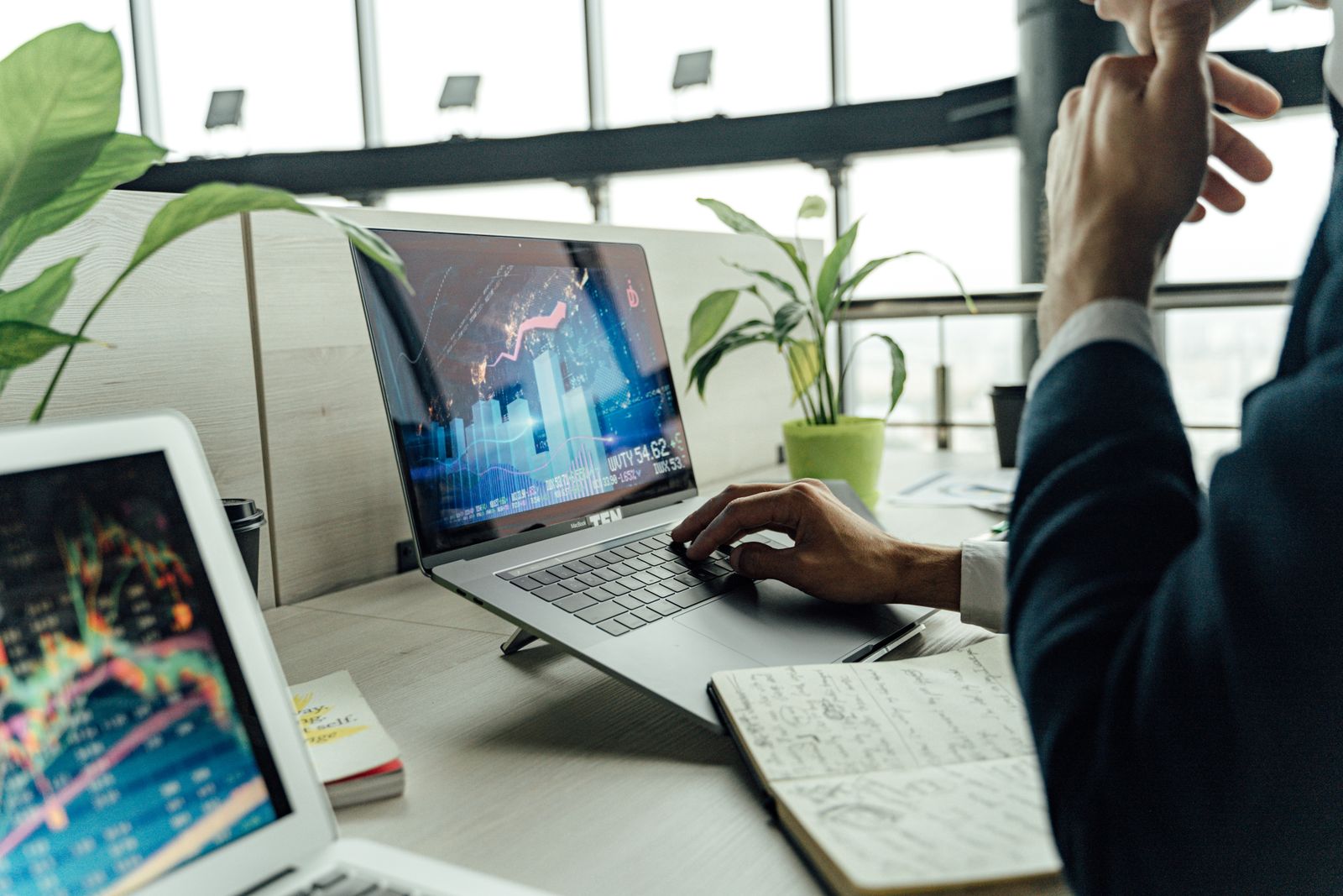 Business professional working on a laptop in a bright office