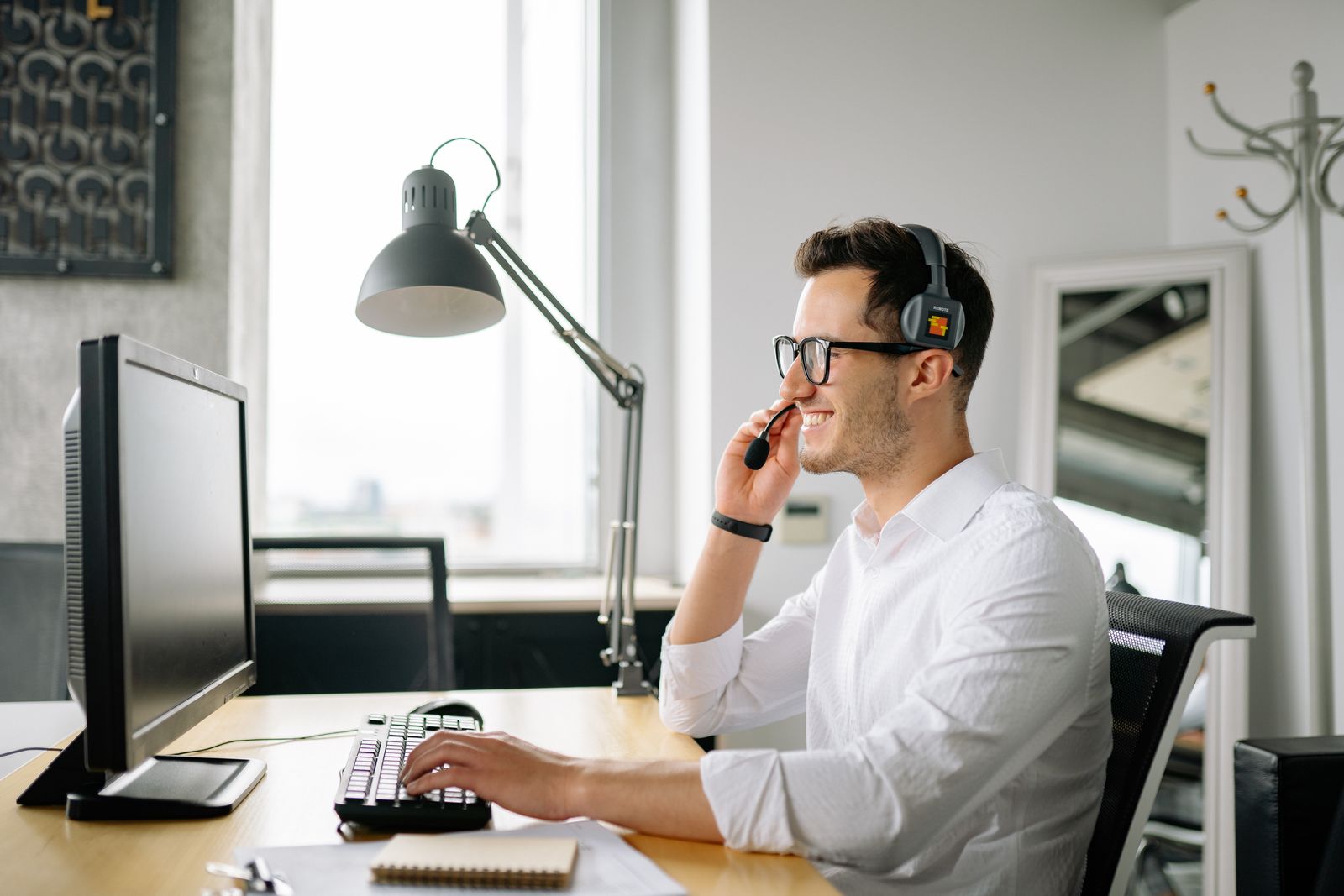 Business professional using a VoIP headset phone system at a Central Florida office desk