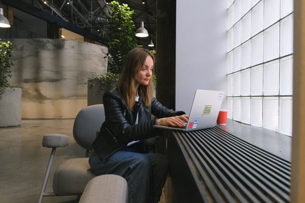 Business owner reviewing website and domain account details on a laptop in a modern office