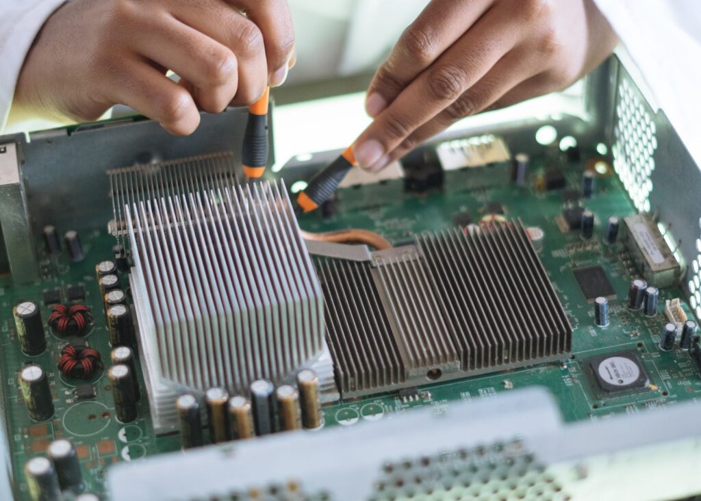 Technician working inside an open desktop computer to upgrade hardware