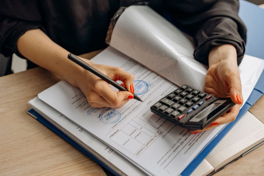 Small business owner reviewing compliance paperwork at a desk