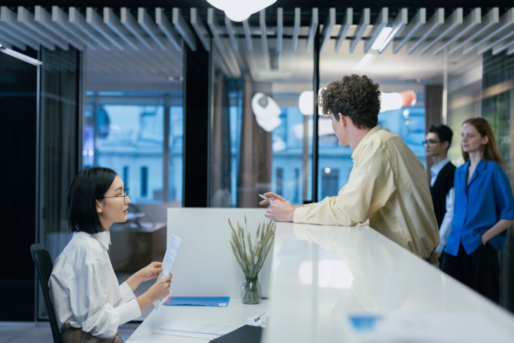 Manager meeting with an employee at an office reception desk