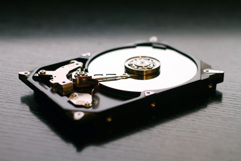 Open hard drive showing platter and read head, data recovery in Orlando