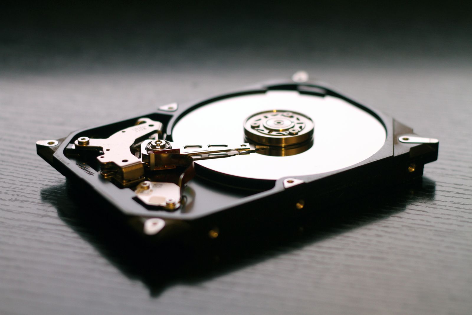 Open hard drive showing platter and read head, data recovery in Orlando