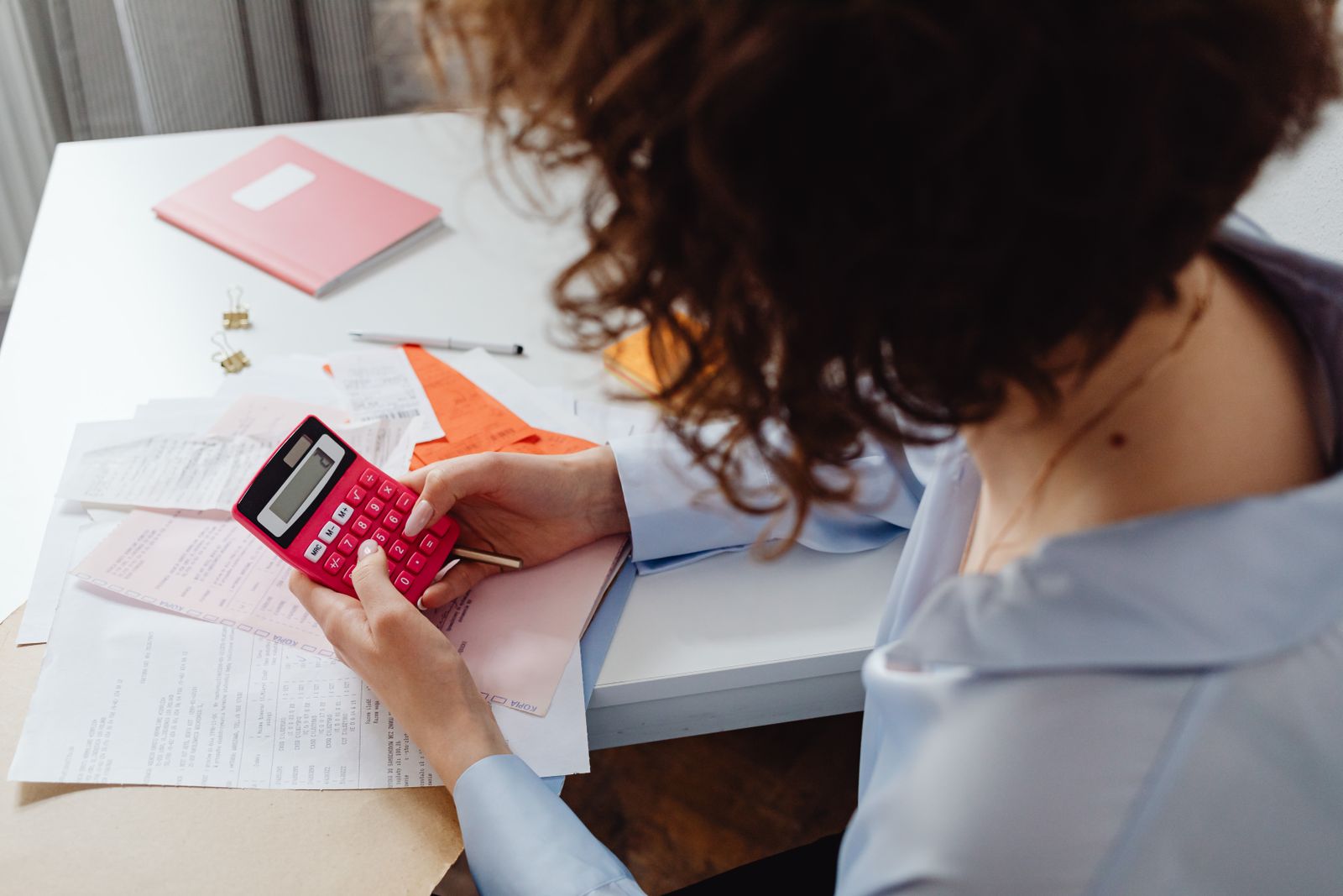 Small business owner using a calculator to work out IT support cost