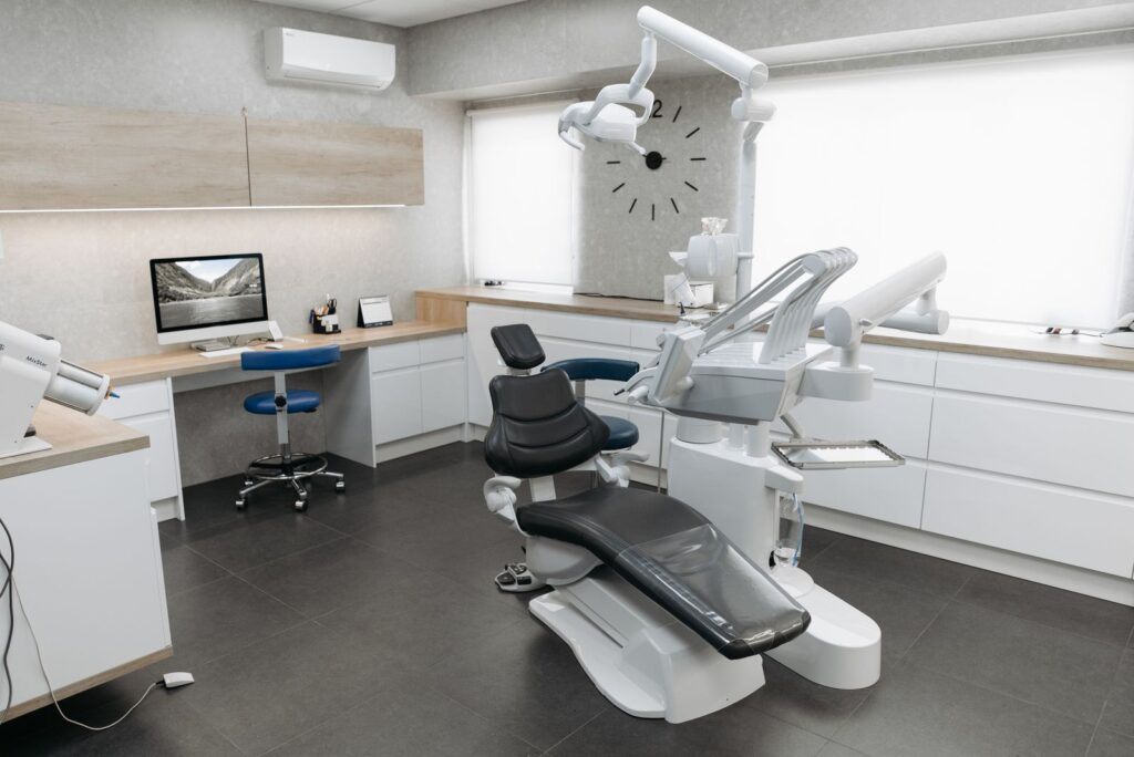 Modern dental operatory with treatment chair and a computer workstation in a Central Florida dental office