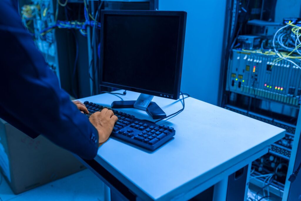 IT support technician in Leesburg FL working on a business network server rack