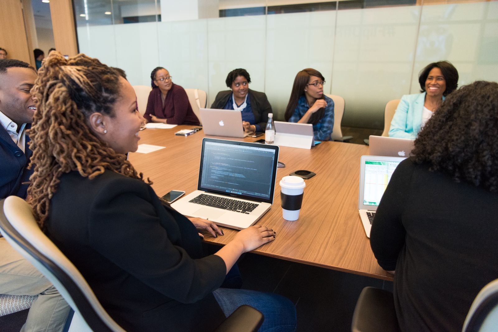 Small business team meeting around a conference table with laptops