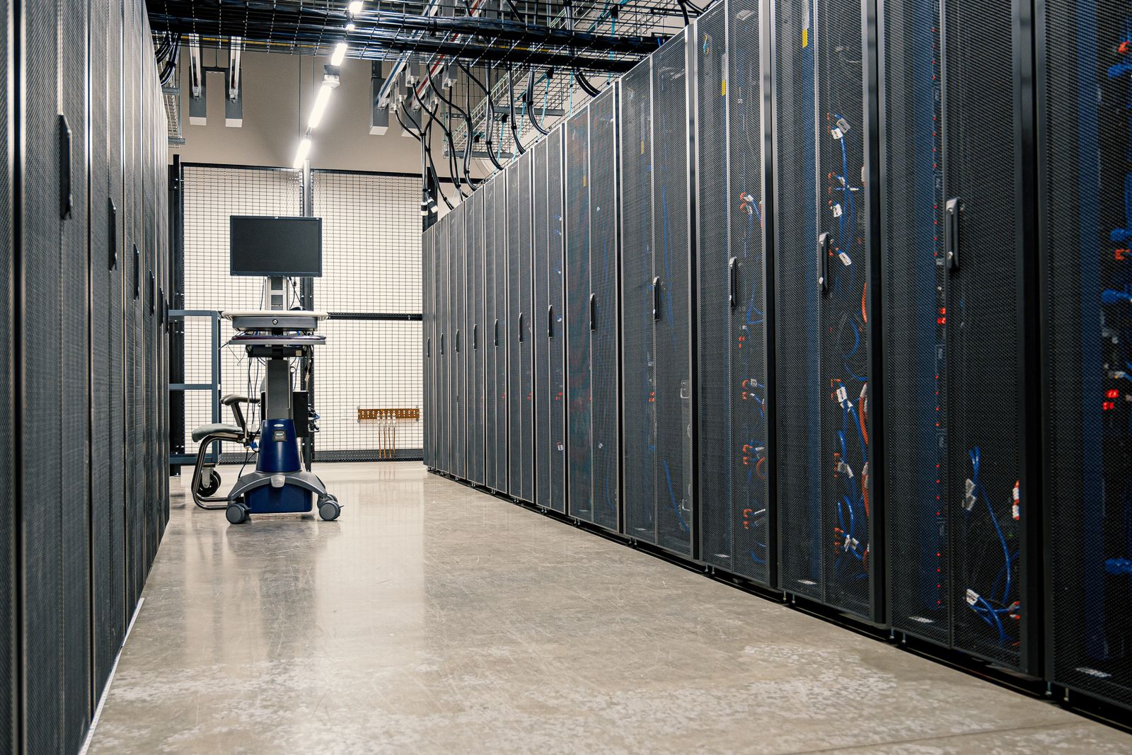 Rows of server racks and network cabinets in a modern data center