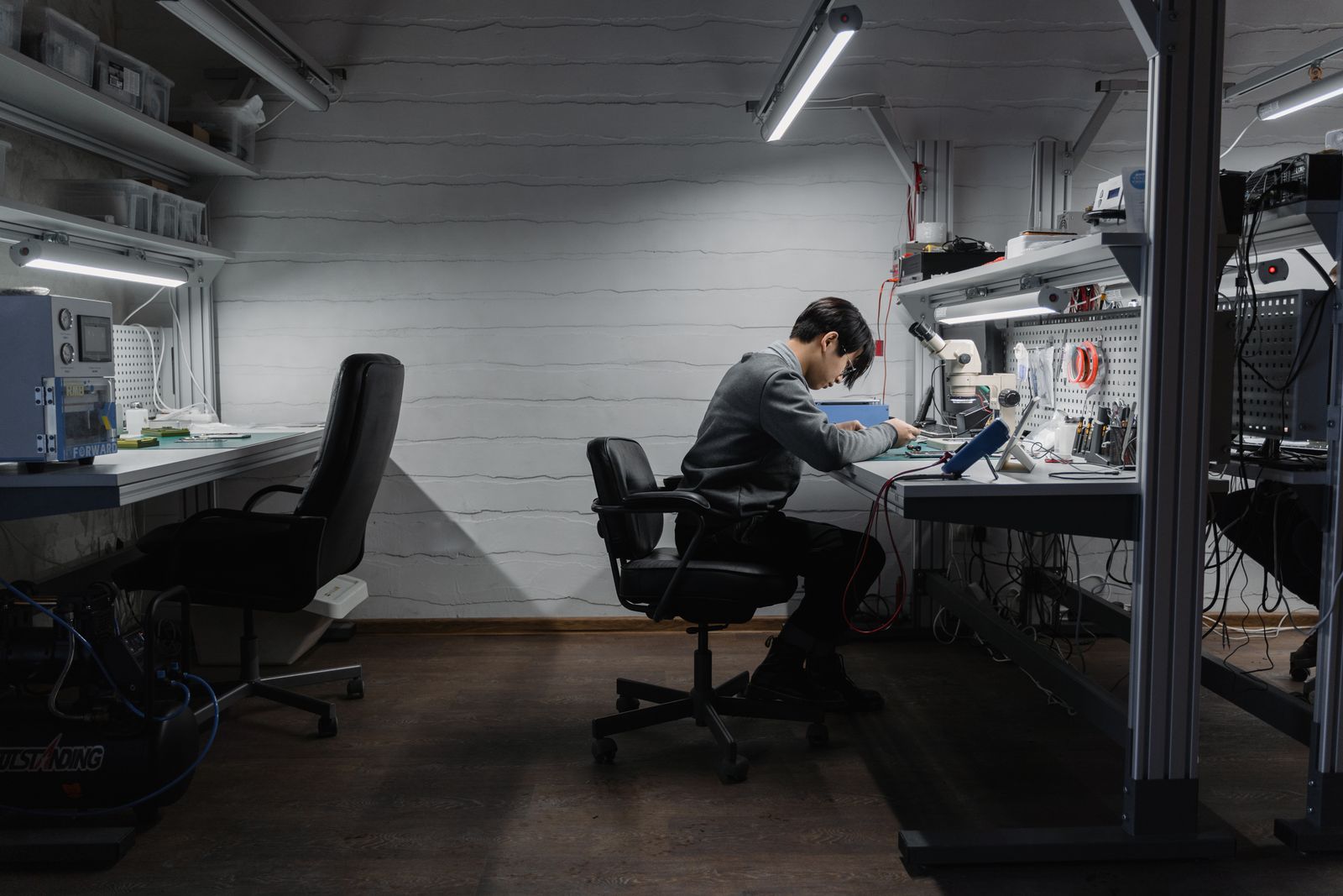 IT technician working at a repair bench in a local service shop