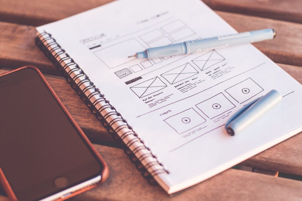 Website layout sketched on a notepad while planning a small business website budget