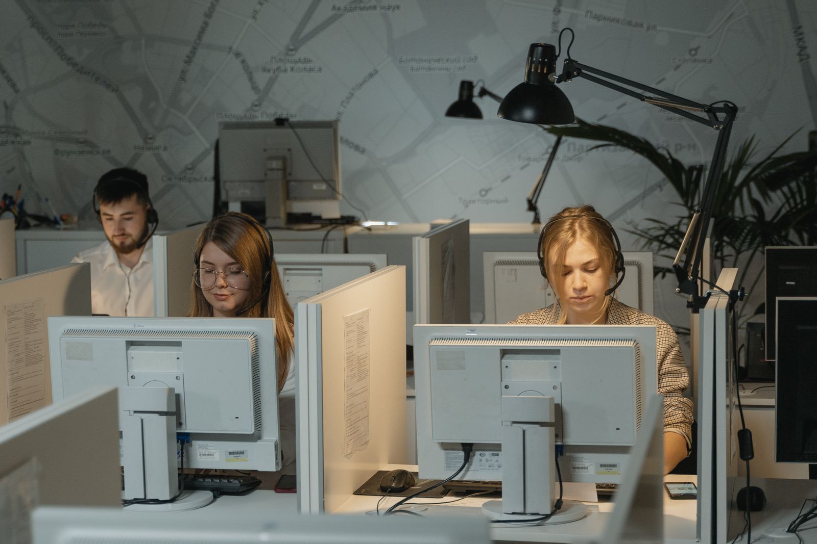 IT support technicians with headsets answering calls at their desks