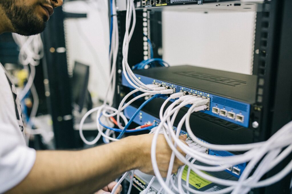 Technician installing business Wi-Fi network equipment in a Central Florida office