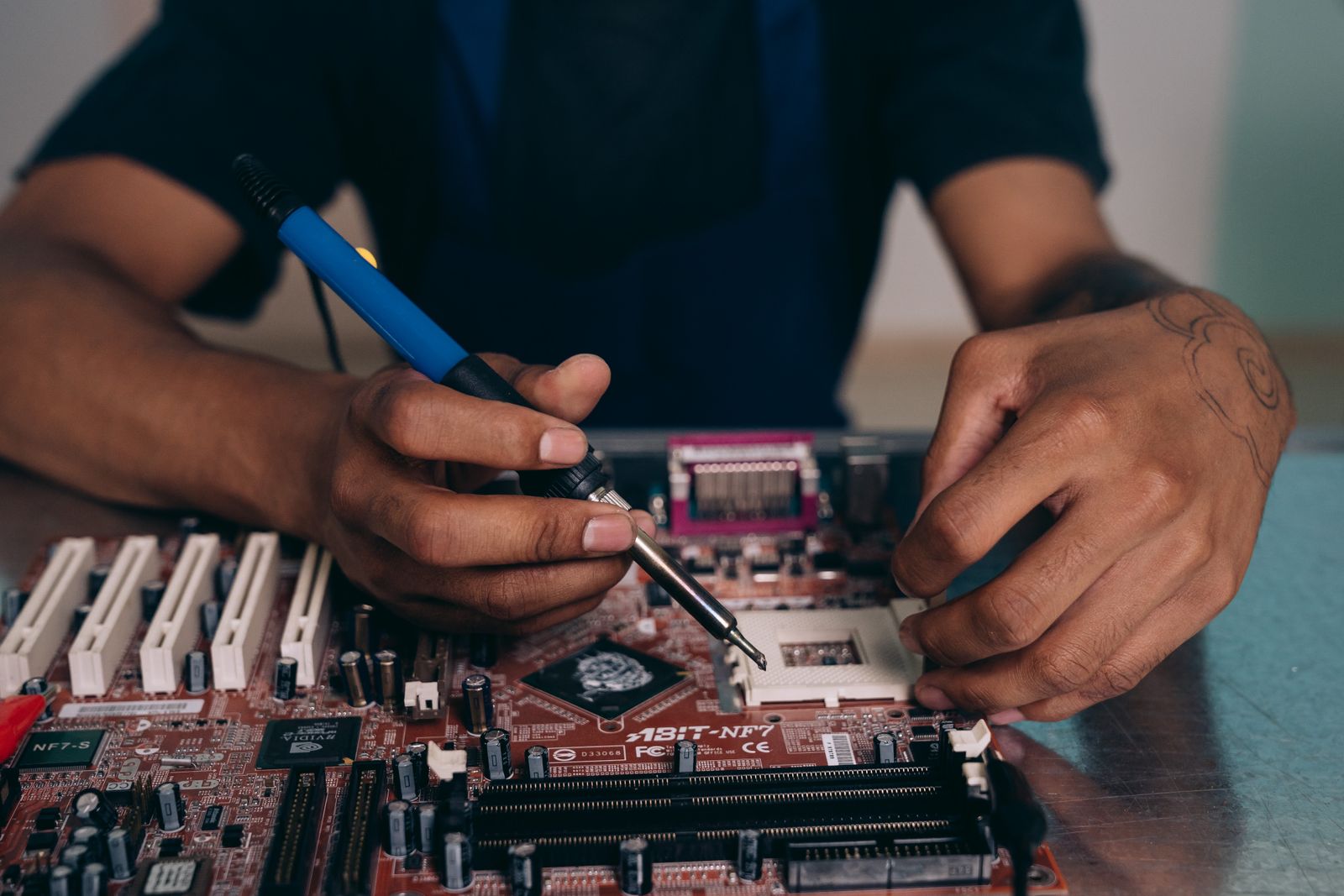 Technician repairing a computer motherboard in Apopka FL