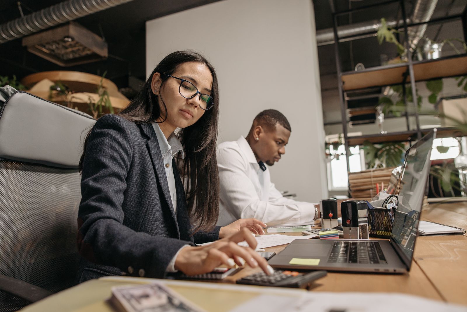 Accountants working at laptops in a CPA firm office in Central Florida