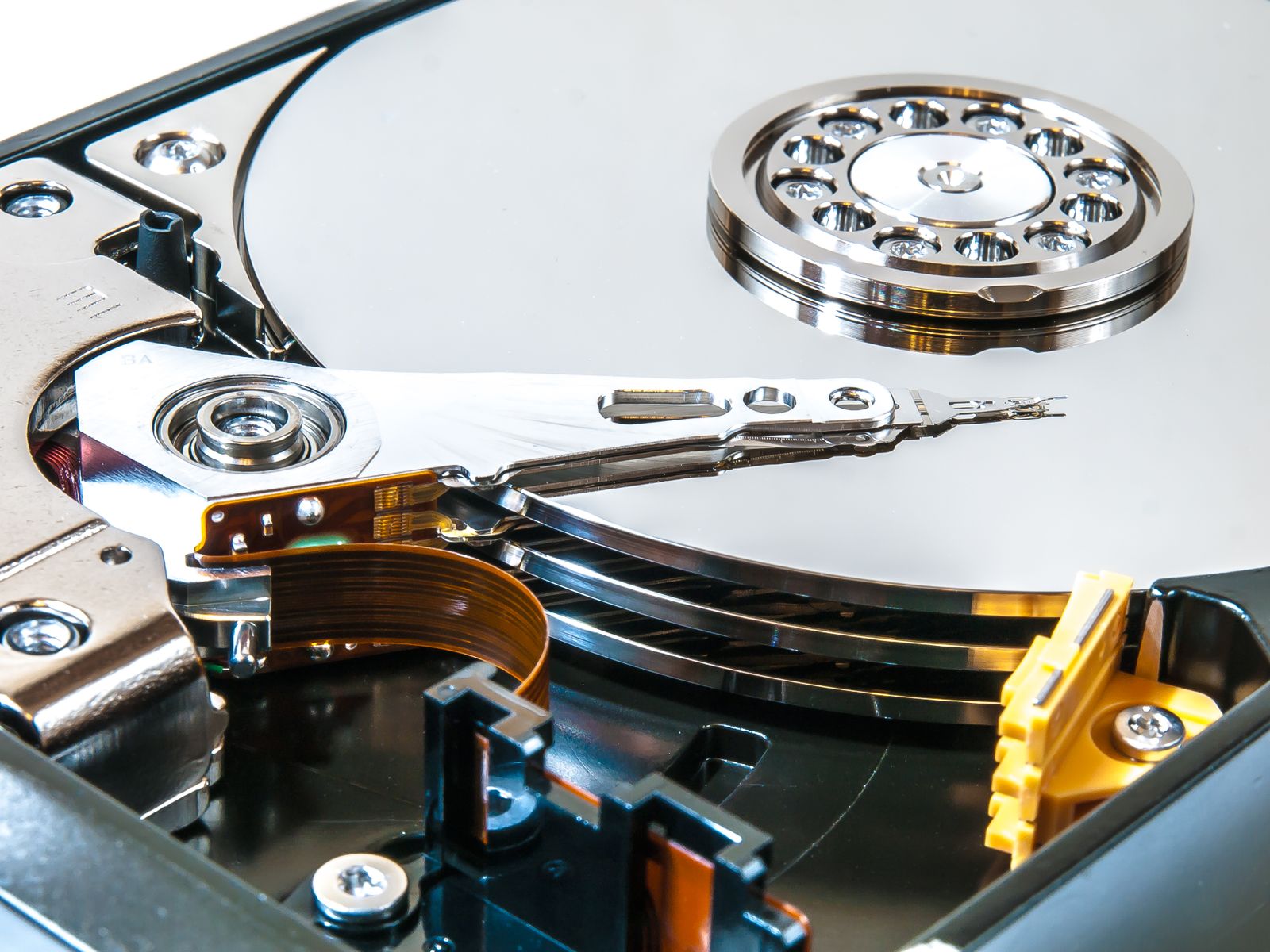 Open hard drive showing the read write head arm over the platter
