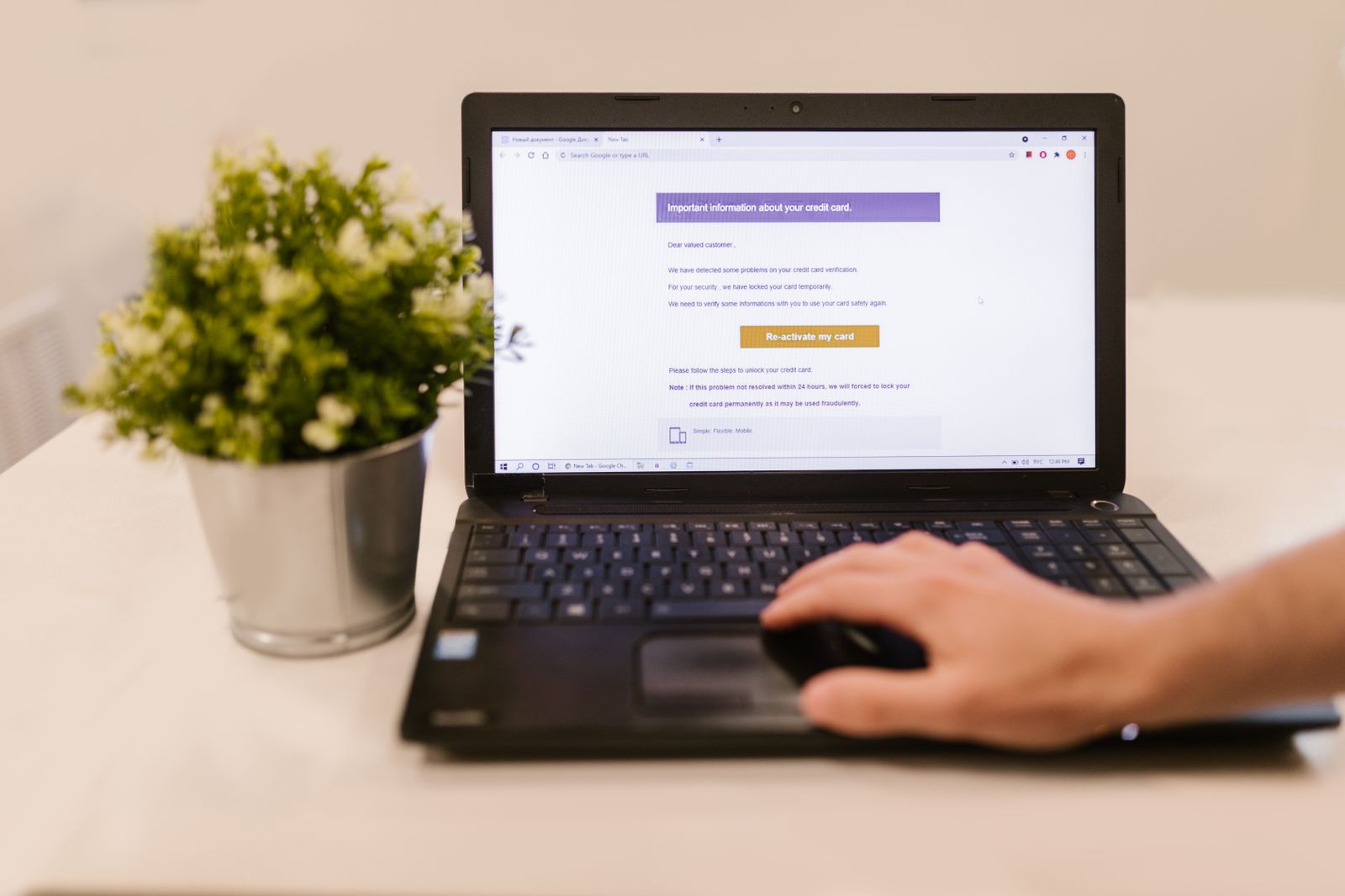 Person reading a suspicious account email on a laptop after their email account was hacked