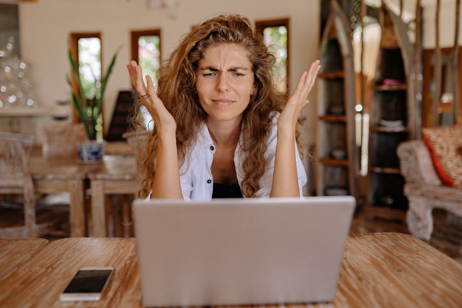 Frustrated woman waiting on a slow laptop at home