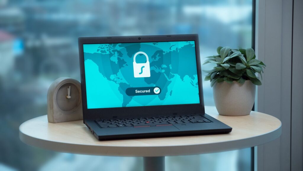 Laptop displaying a secured padlock website icon on an office desk