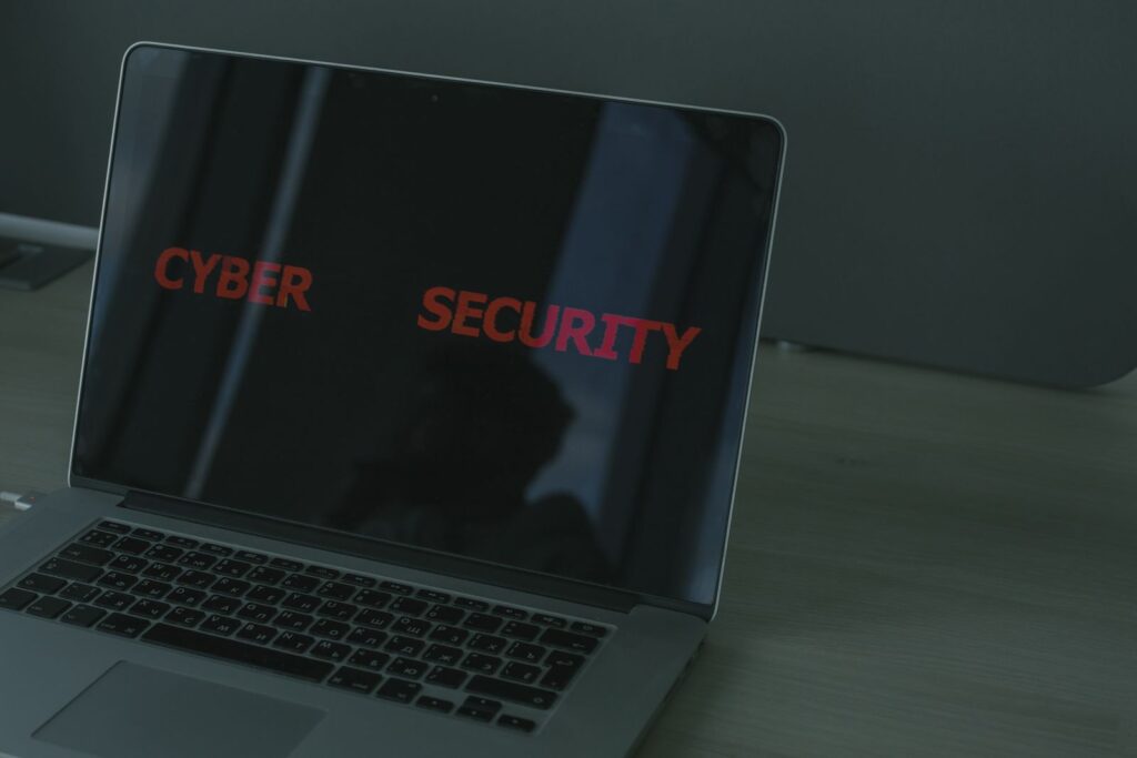 Laptop screen showing a cyber security warning in a dark office